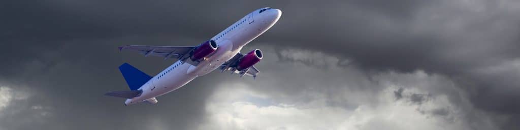 corporate plane ascending into dark clouds