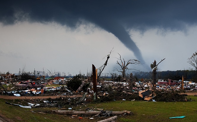 destroyed homes with tornado in background