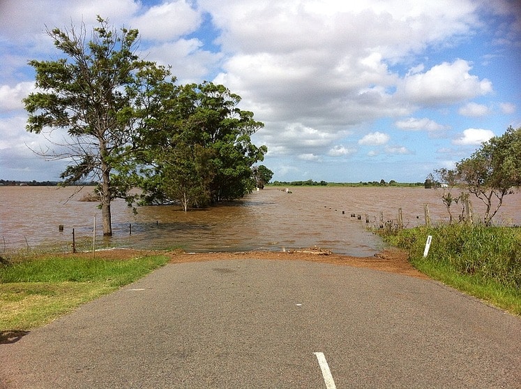 flooded rural road with fence lines