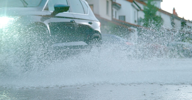 Car driving through watery streets