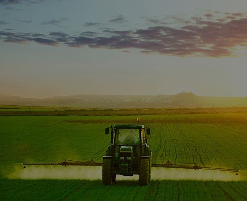 tractor spraying at dawn resource half