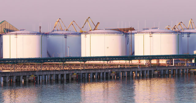 oil tankers near water at dusk