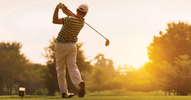 golfer backswing at sunrise