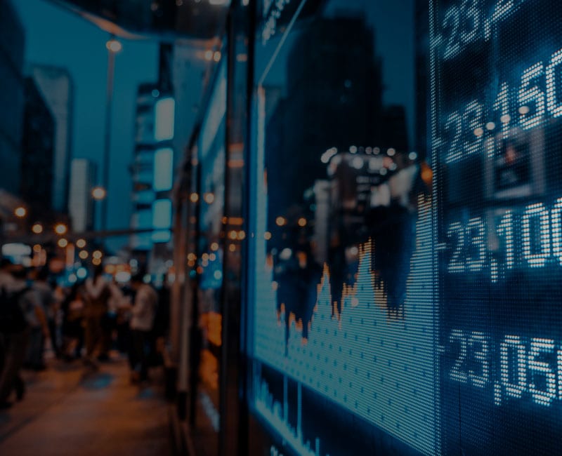 stock ticker and charts along sidewalk