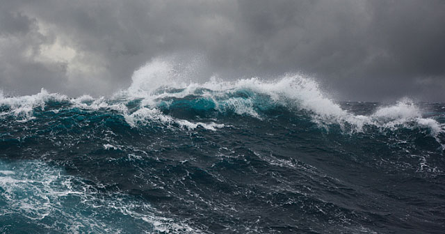 deep blue sea waves with stormy skies