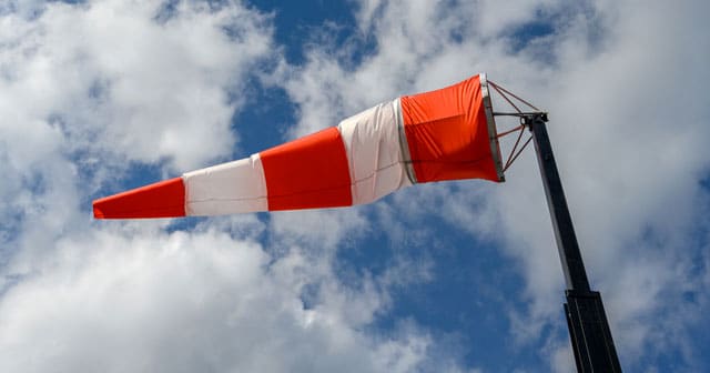 news insights wind sock blue sky clouds