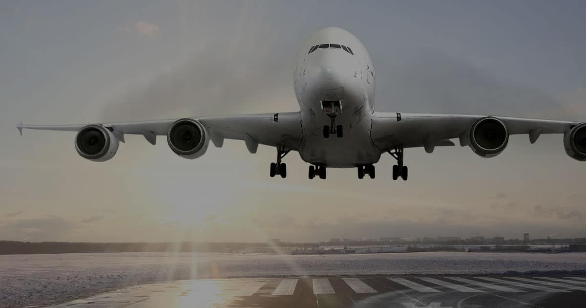 Aircraft IceGuard commercial plane landing frozen runway sunrise