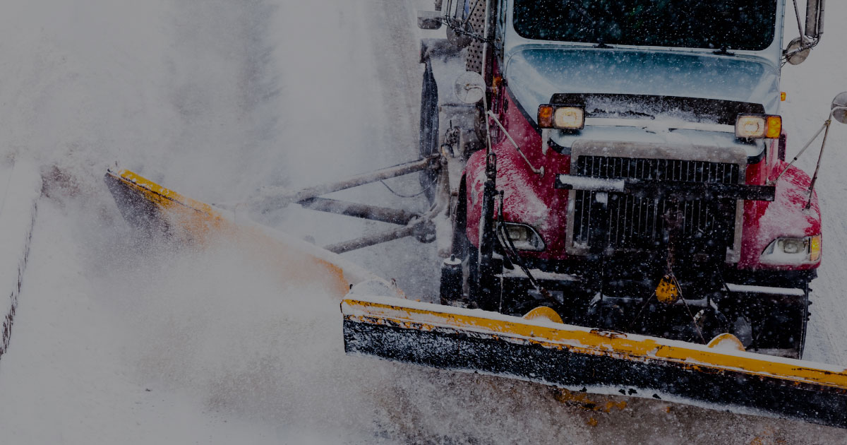 RoadMaster red and blue snow plow truck heavy wet snow