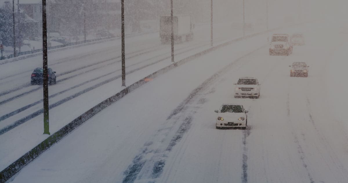 RoadMaster cars on highway white out blizzard snow
