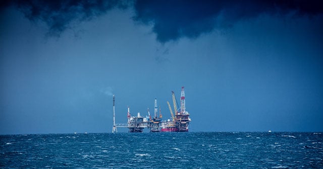 offshore oil rig with dark clouds and stormy seas
