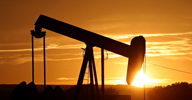 Sunrise in oil field Pumpjack Silhouette