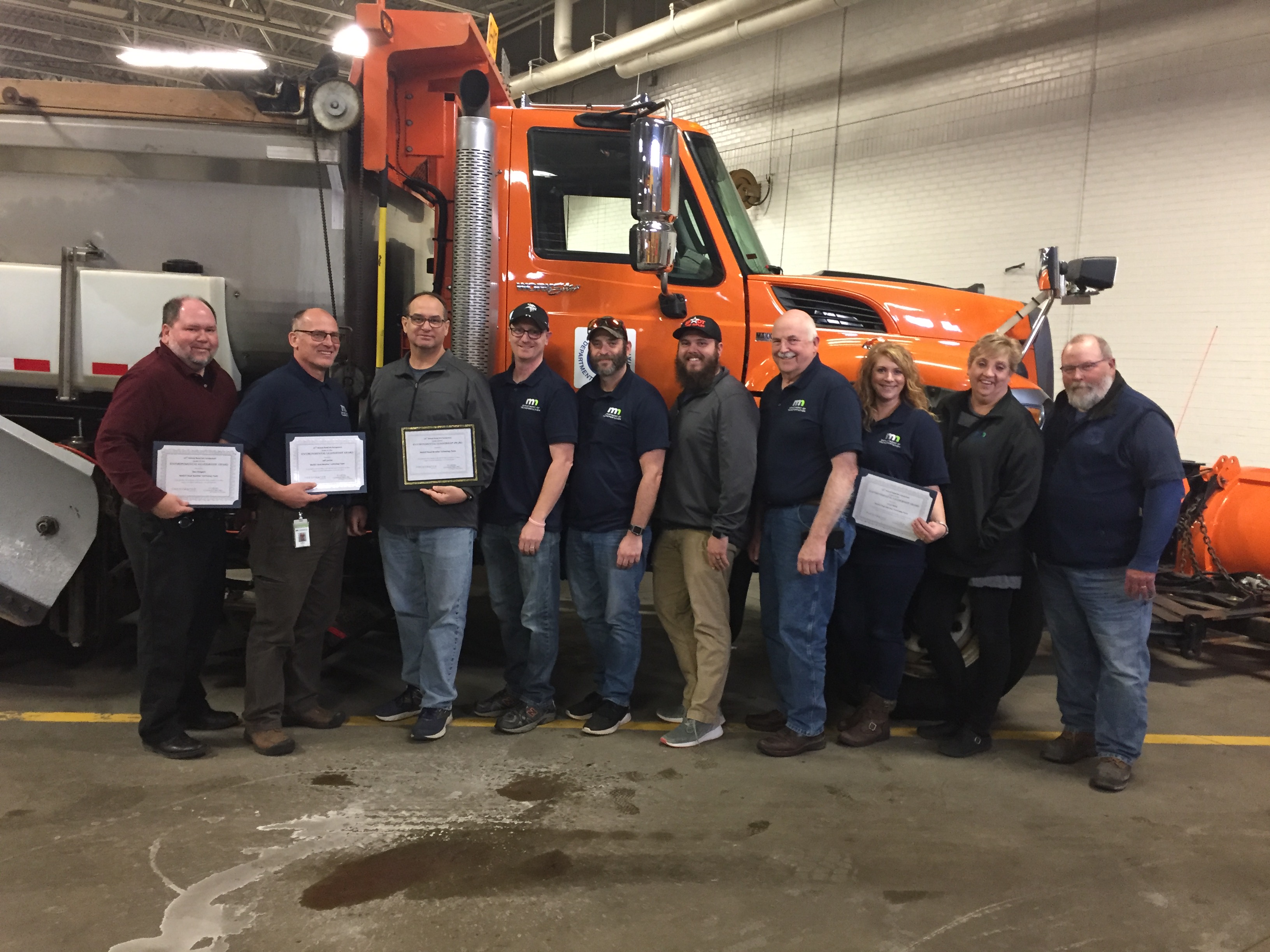 MnDOT’s Road Weather Technology team poses with its Environmental Stewardship Award from the Freshwater Society