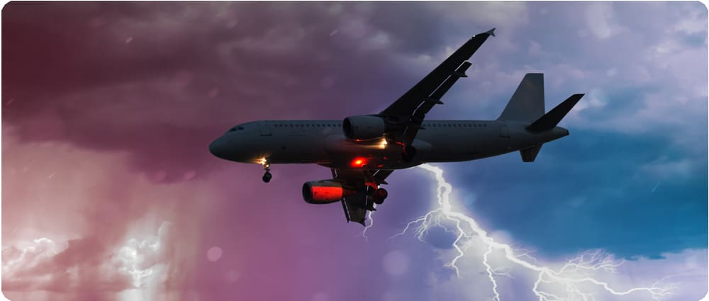 Airplane flying with lightning in the background