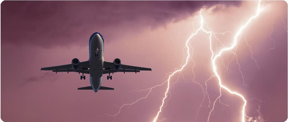 Airplane flying in the sky with lightning
