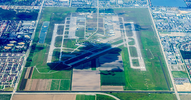 commercial airport aerial view shadow of a cloud