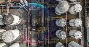 Aerial view of industrial oil storage tank farm and distribution terminal with tanker truck