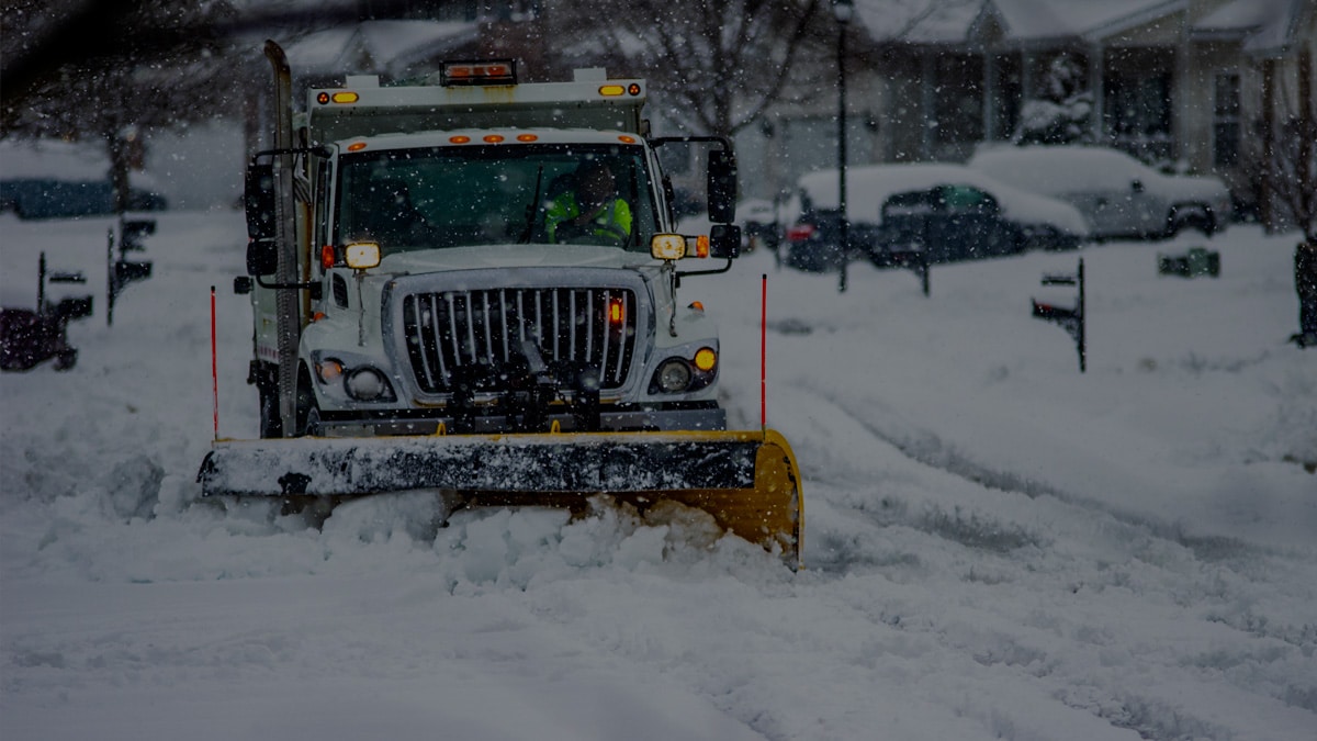 Truck plowing snowy road