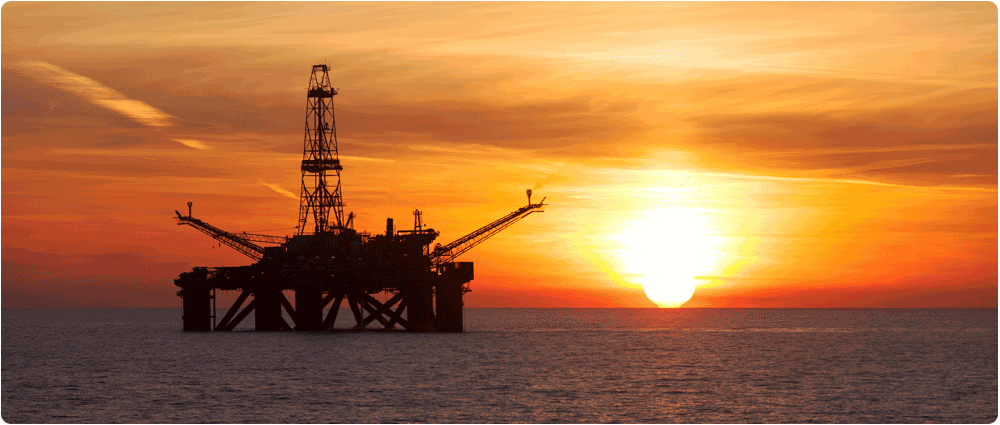 Offshore oil platform silhouette during sunrise