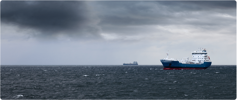 Two ships sailing with dark clouds forming