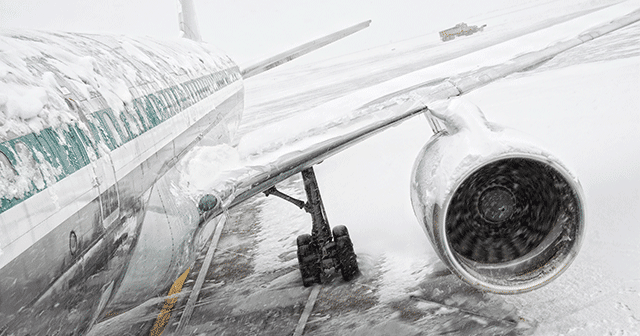 Deicing an airplane wing with lots of snow before takeoff : r