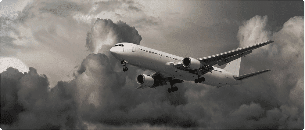 Airplane flying in gray cloudy sky