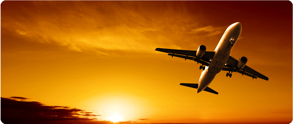 Airplane flying with sun rising