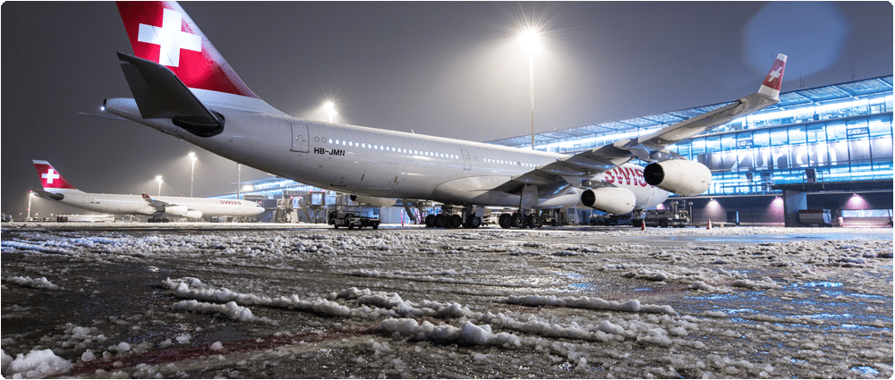 Swiss airplanes on icy tarmac