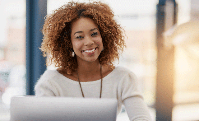 Smiling woman in front of computer