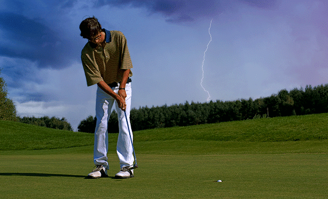 Golfer with lightning in distance
