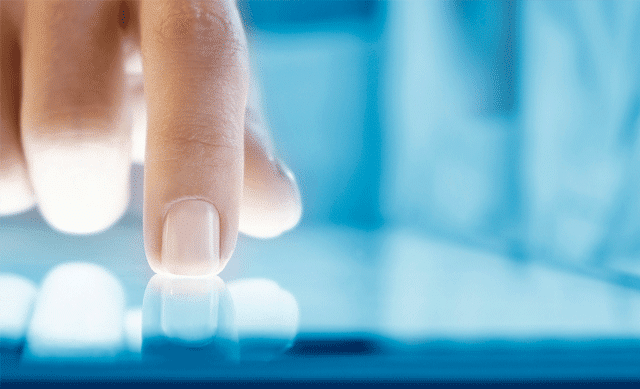 Finger on tablet screen