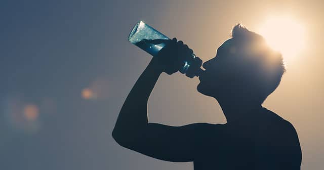 news insights athlete drinking from water bottle sunny day