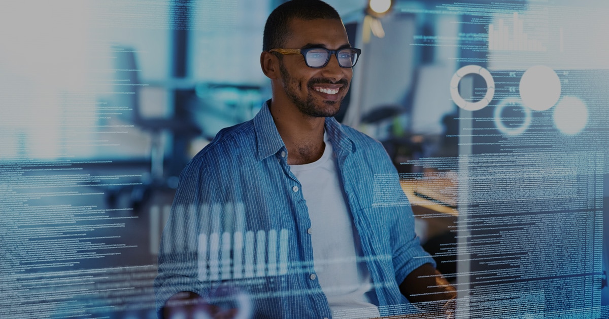 Benefits Man smiling in front of data screen