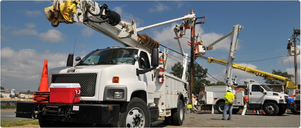 Power lines with utility trucks