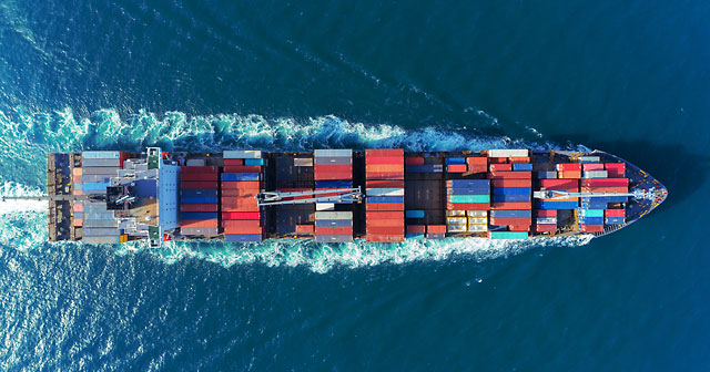 Aerial view Top speed with beautiful wave of container ship full load container.