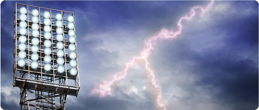Stadium lighting with lightning in the sky