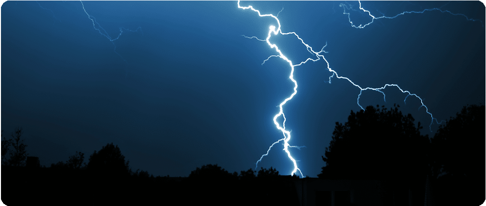 Lightning with tree silhouette