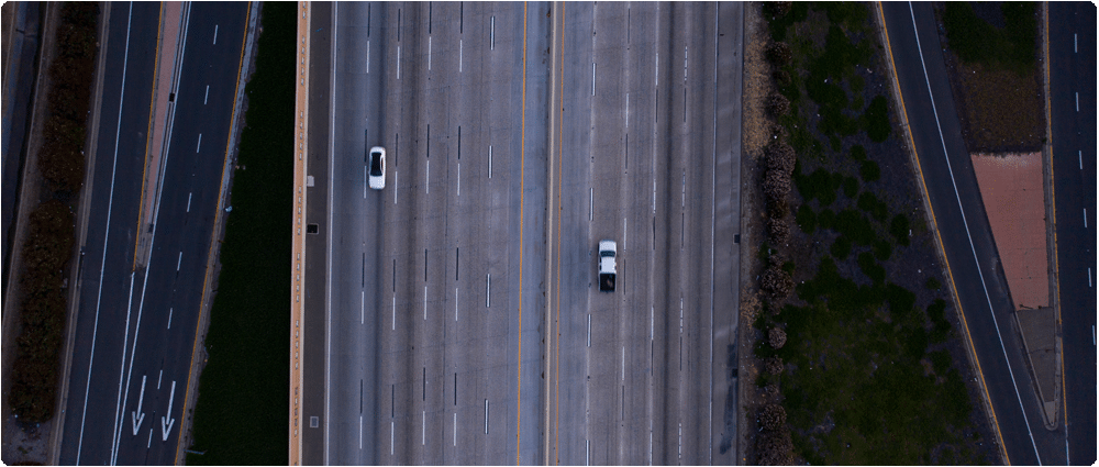 Aerial view of two cars on open highway