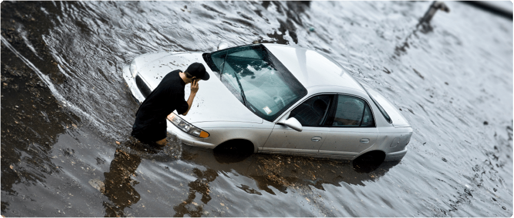 Car stuck in flooded street