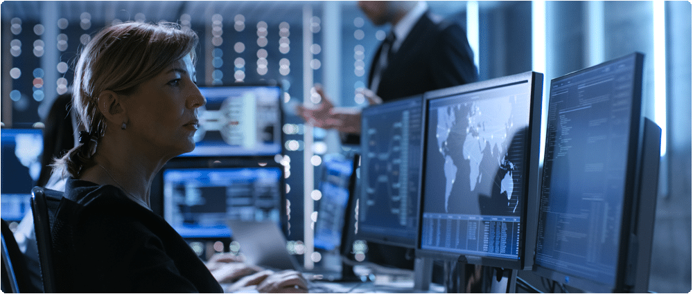 Woman looking at computer monitors