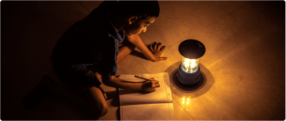 Young boy writing in the dark