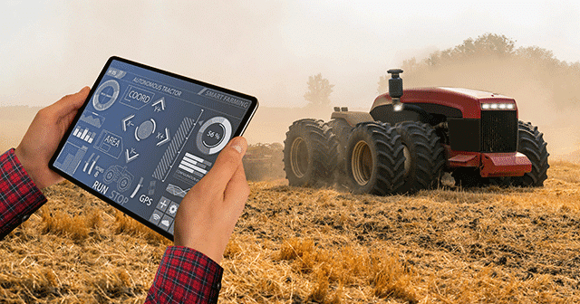 Blog header Farmer with tablet operating tractor