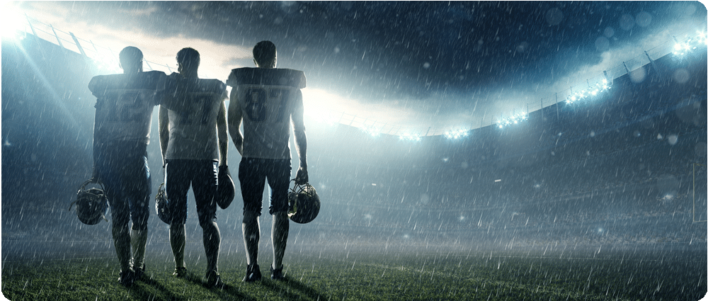 Football players standing in the rain