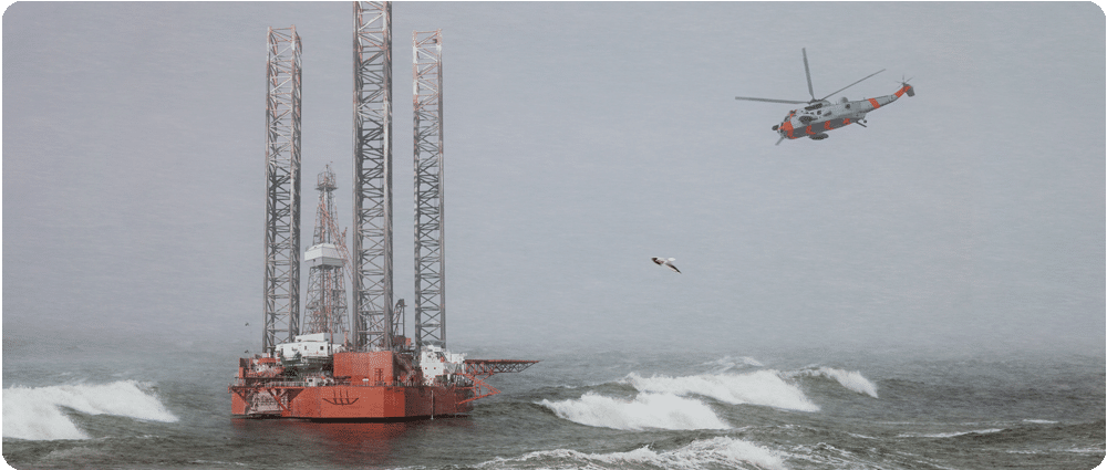 Helicopter flying to offshore platform