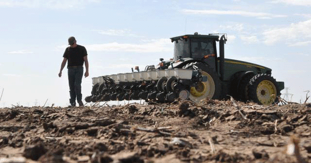 Farmer next to tractor