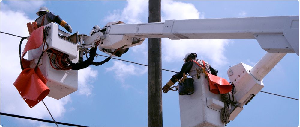Utility workers in cherry pickers