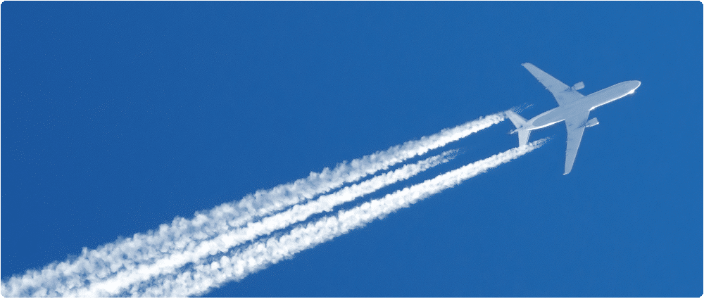 Airplane in blue sky with contrail