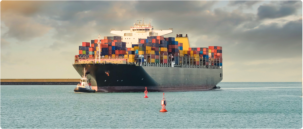 Large cargo ship with tugboat