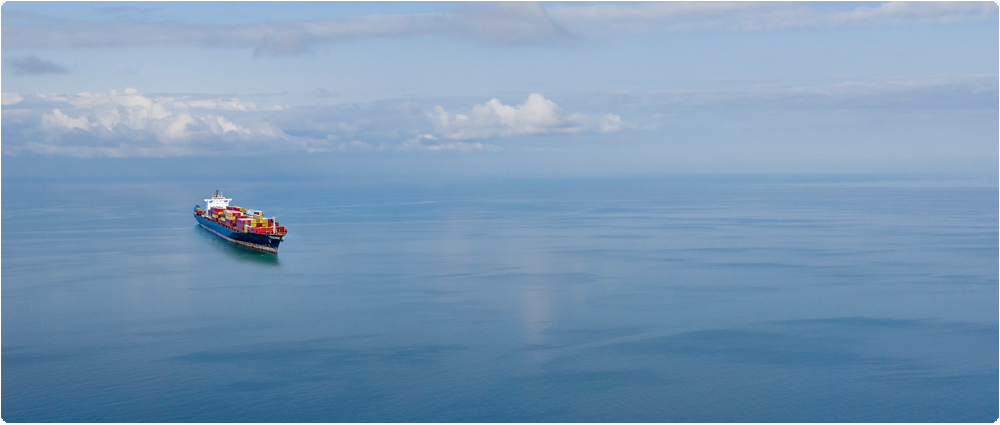 Container ship open water blue sky