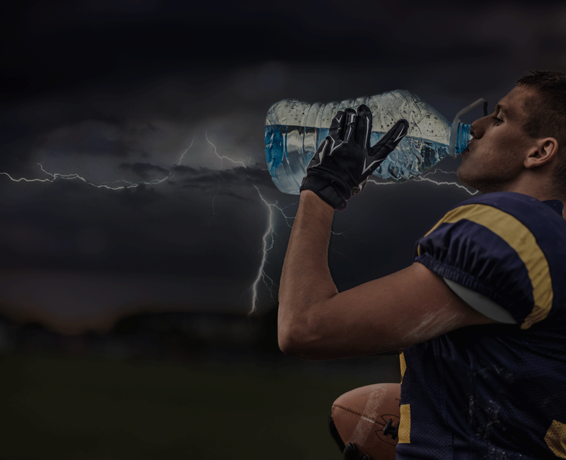 Football player drinking water lightning in the sky Resource