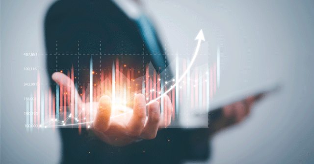 Businessman holding market graph